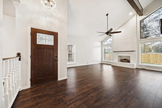 entryway featuring beam ceiling, a healthy amount of sunlight, a fireplace, and high vaulted ceiling