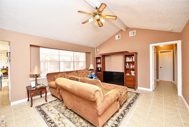 tiled living room featuring a textured ceiling, lofted ceiling with beams, and ceiling fan