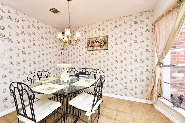dining space featuring light tile patterned floors and a notable chandelier