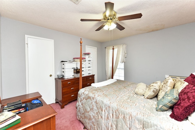 carpeted bedroom with a textured ceiling and ceiling fan
