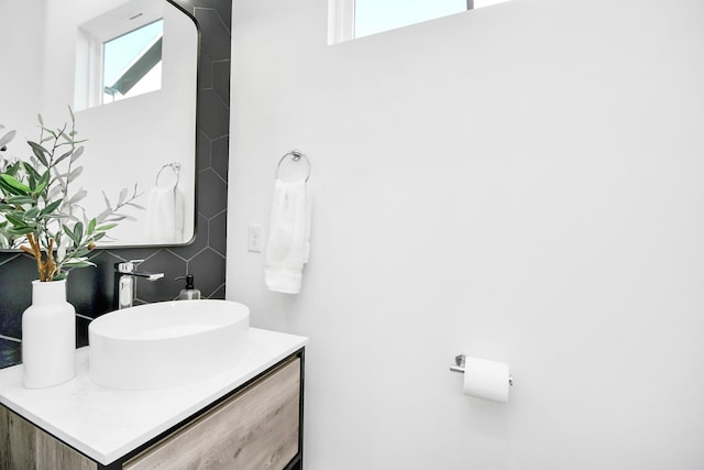 bathroom with vanity and backsplash