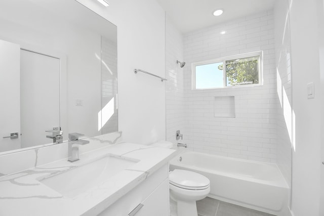 full bathroom with tile patterned floors, tiled shower / bath combo, toilet, and vanity