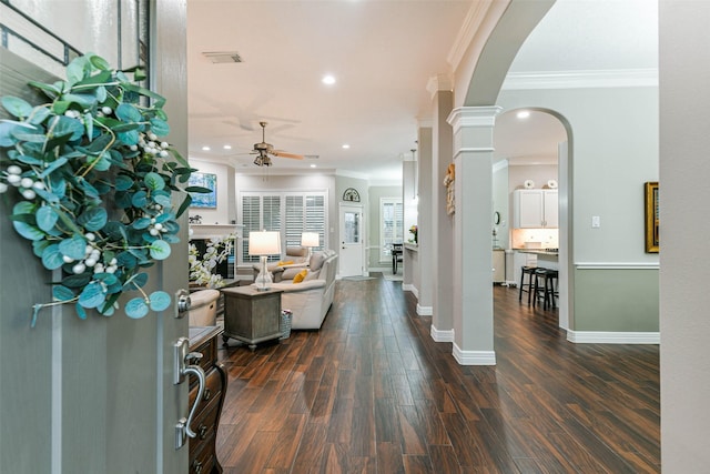 foyer with ceiling fan, dark hardwood / wood-style flooring, and crown molding