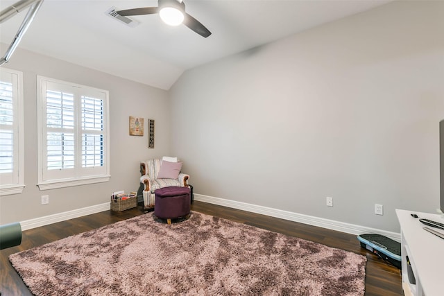 living area with ceiling fan, dark hardwood / wood-style flooring, and lofted ceiling