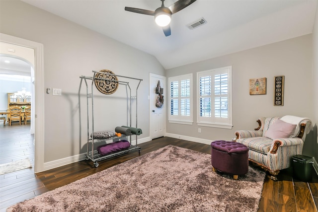 sitting room with ceiling fan, dark hardwood / wood-style flooring, and vaulted ceiling