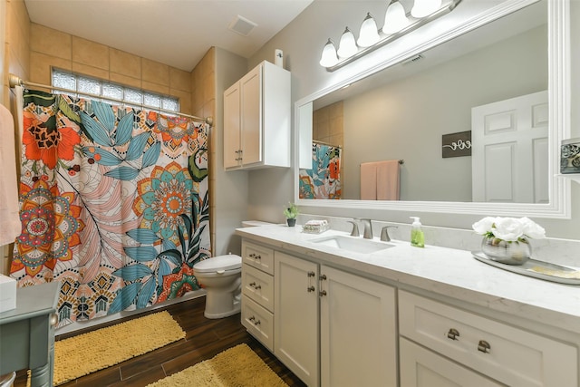 bathroom featuring hardwood / wood-style floors, vanity, and toilet