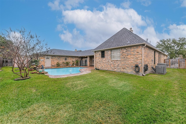 view of pool featuring central AC unit and a lawn