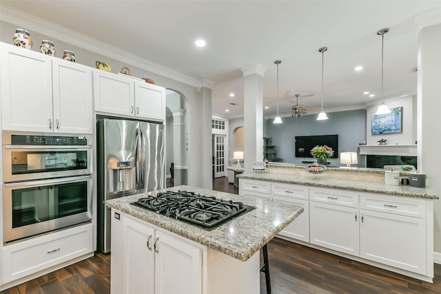 kitchen with kitchen peninsula, white cabinets, and stainless steel appliances