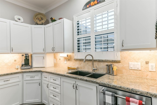 kitchen with white cabinets, backsplash, crown molding, and sink