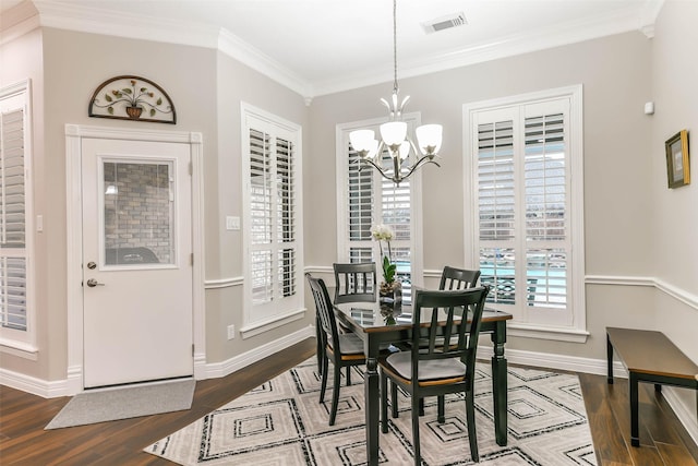 dining area with an inviting chandelier, ornamental molding, and hardwood / wood-style flooring