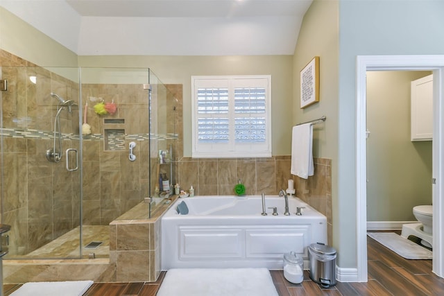 bathroom featuring separate shower and tub, lofted ceiling, and toilet