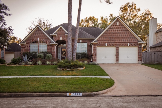 view of front of property featuring a garage and a front lawn