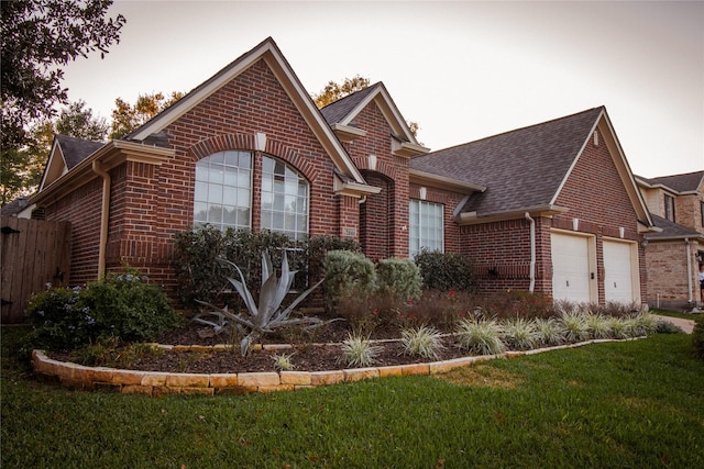 view of front facade with a garage and a front yard