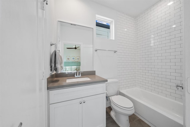 full bathroom with tile patterned floors, vanity, tiled shower / bath combo, ceiling fan, and toilet