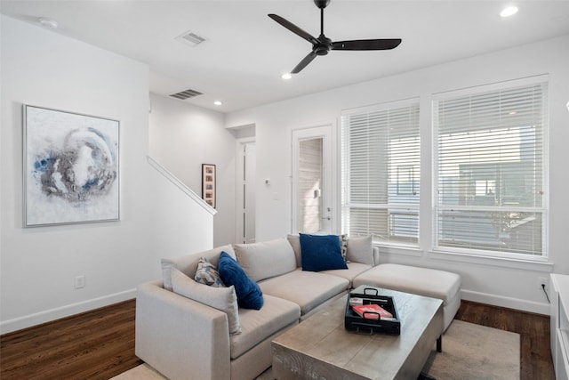 living room with ceiling fan and dark hardwood / wood-style flooring