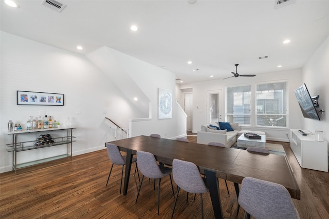 dining space featuring ceiling fan and dark wood-type flooring