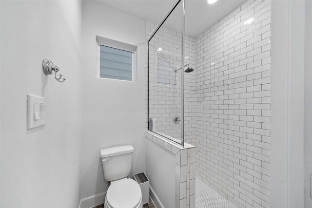 bathroom with tiled shower and toilet