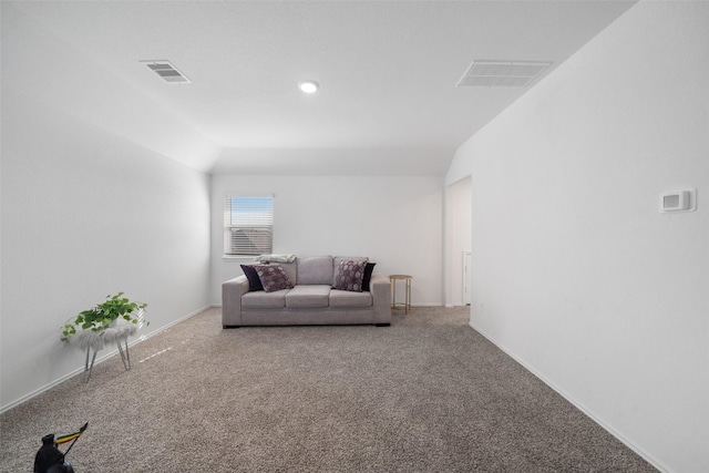 carpeted living room with lofted ceiling