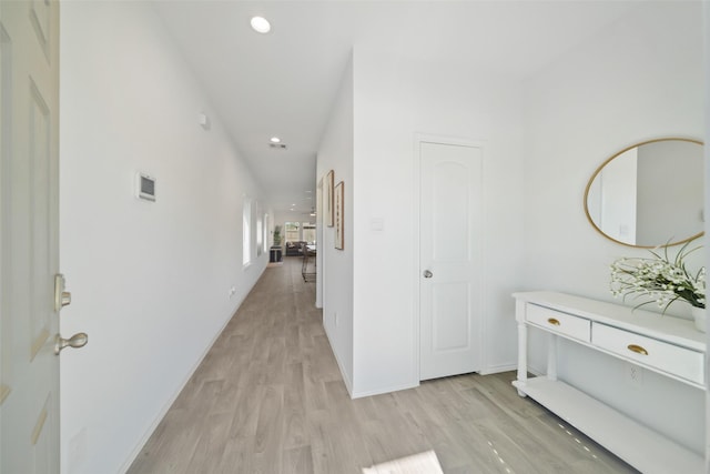 corridor with recessed lighting, light wood-style floors, and baseboards