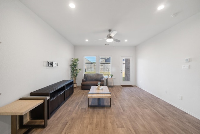 living room featuring ceiling fan and hardwood / wood-style floors