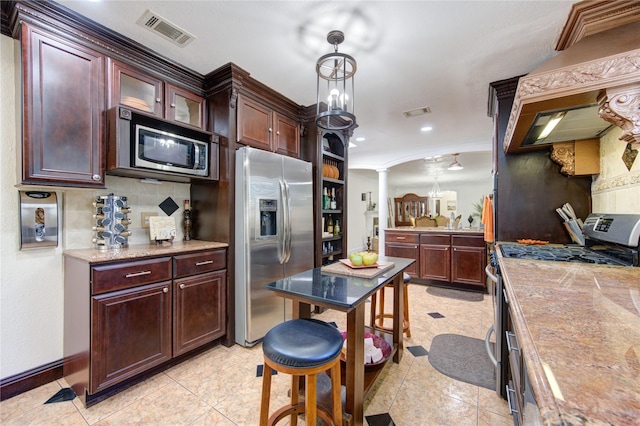 kitchen with decorative backsplash, appliances with stainless steel finishes, ornate columns, and light tile patterned flooring