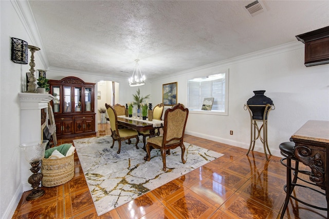 dining room featuring crown molding, a textured ceiling, and a chandelier