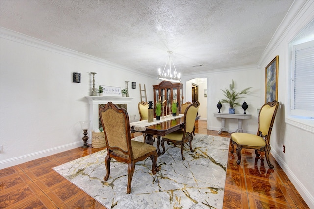 dining space with tile patterned floors, a textured ceiling, an inviting chandelier, and ornamental molding