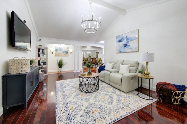 living room featuring dark wood-type flooring, an inviting chandelier, lofted ceiling with beams, crown molding, and ornate columns