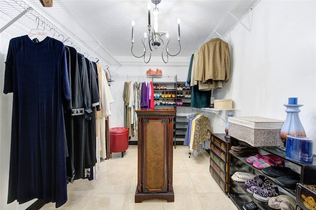 spacious closet featuring light tile patterned flooring and a notable chandelier