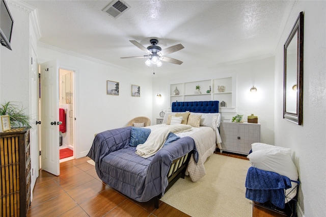 tiled bedroom with a textured ceiling, ceiling fan, and ornamental molding