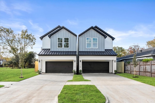 modern inspired farmhouse featuring a front lawn and a garage