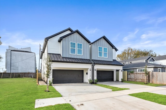 modern farmhouse featuring fence, a standing seam roof, concrete driveway, a garage, and board and batten siding