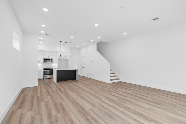 unfurnished living room featuring light wood-type flooring