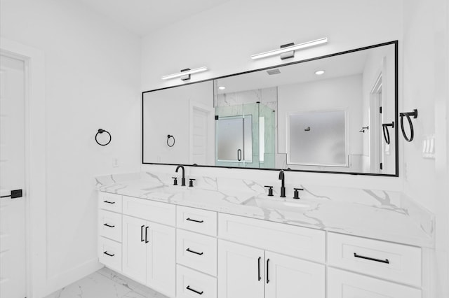 bathroom with vanity and a shower with shower door