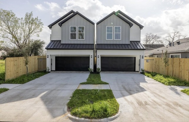 modern inspired farmhouse featuring board and batten siding, an attached garage, and a standing seam roof