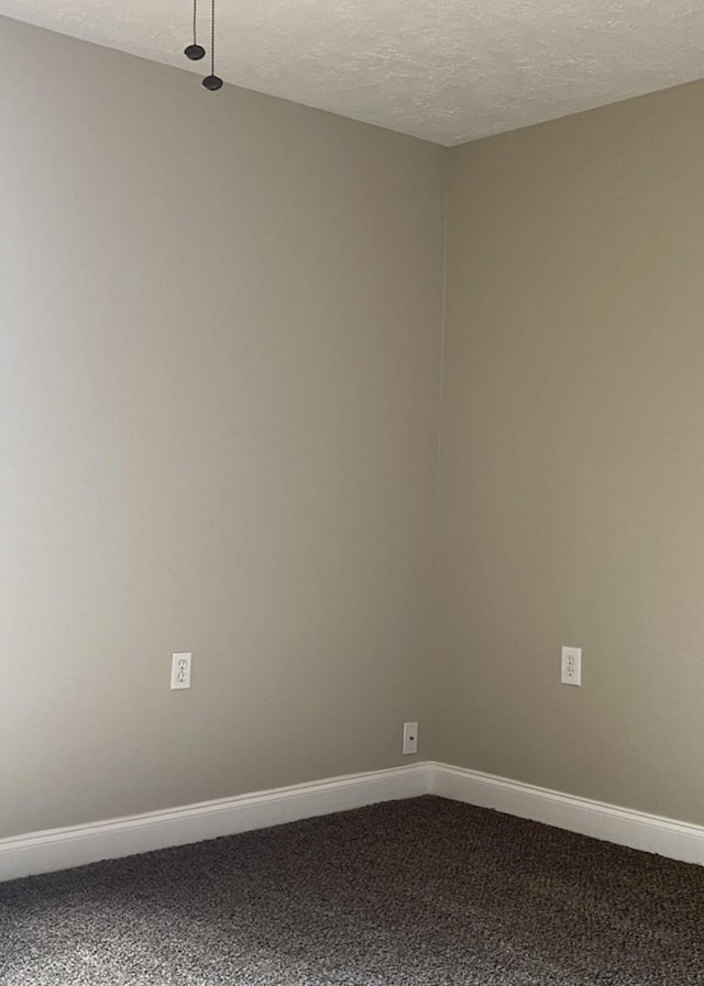 carpeted spare room with a textured ceiling