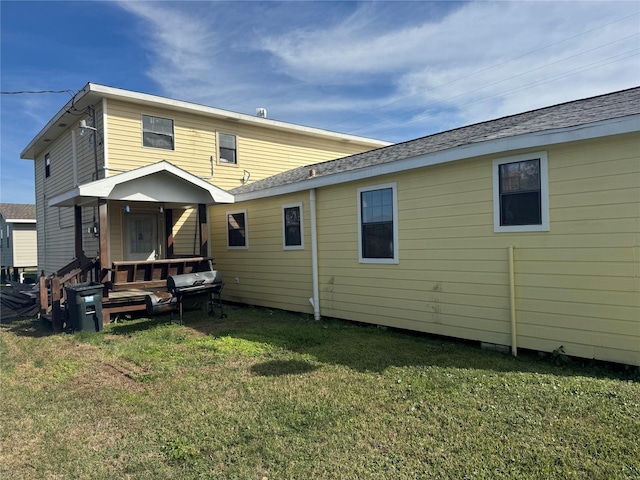 rear view of house with a yard