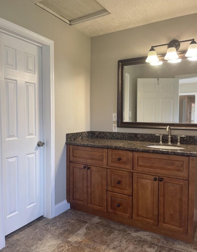 bathroom with vanity and a textured ceiling