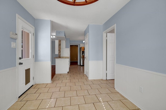 hallway featuring light tile patterned floors