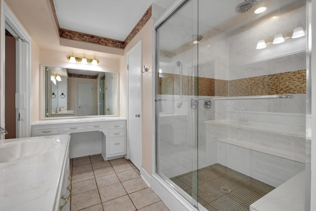 bathroom featuring tile patterned flooring, vanity, and walk in shower