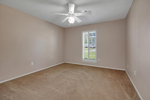 spare room with carpet and ceiling fan