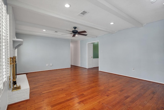 unfurnished living room featuring ceiling fan, beamed ceiling, and wood-type flooring