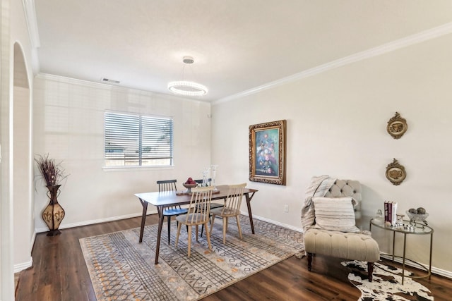 dining area featuring ornamental molding and dark wood-type flooring