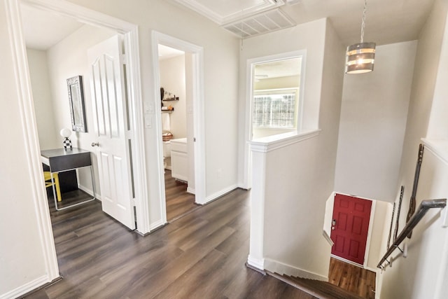 corridor with an inviting chandelier and dark wood-type flooring