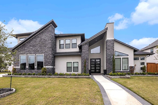 contemporary home with a front yard and french doors