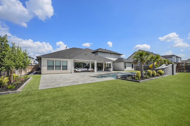 rear view of property featuring an outdoor hangout area, a fenced in pool, a patio, and a yard