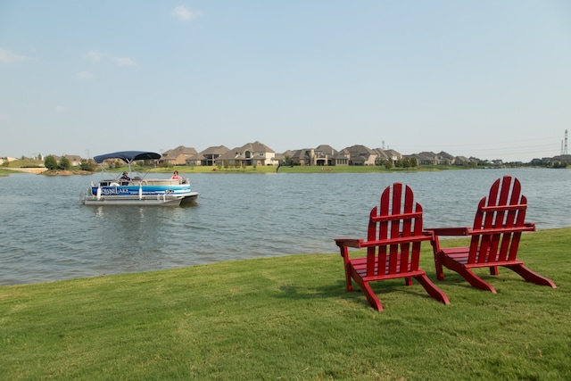 dock area with a water view and a yard