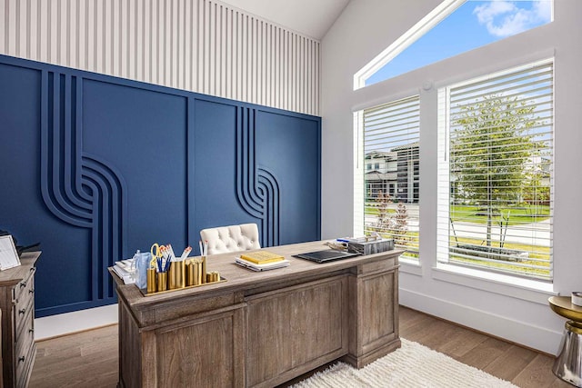 office featuring vaulted ceiling and hardwood / wood-style flooring