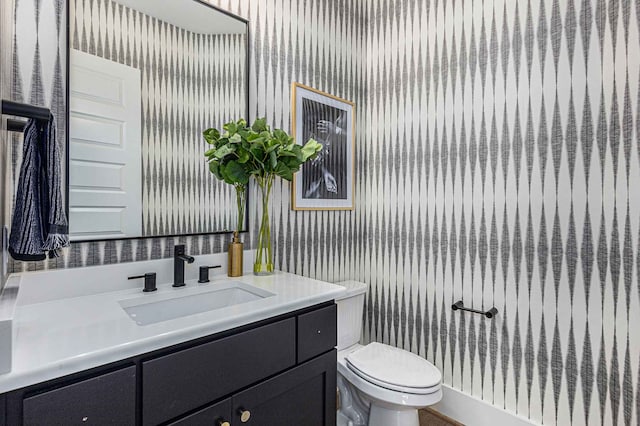 bathroom featuring toilet and vanity