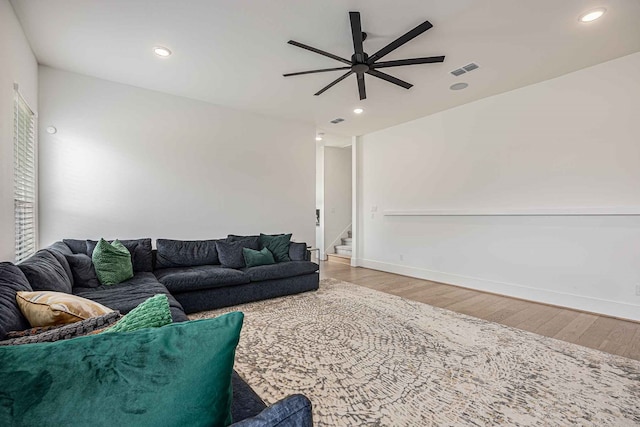 living room with ceiling fan and light hardwood / wood-style floors